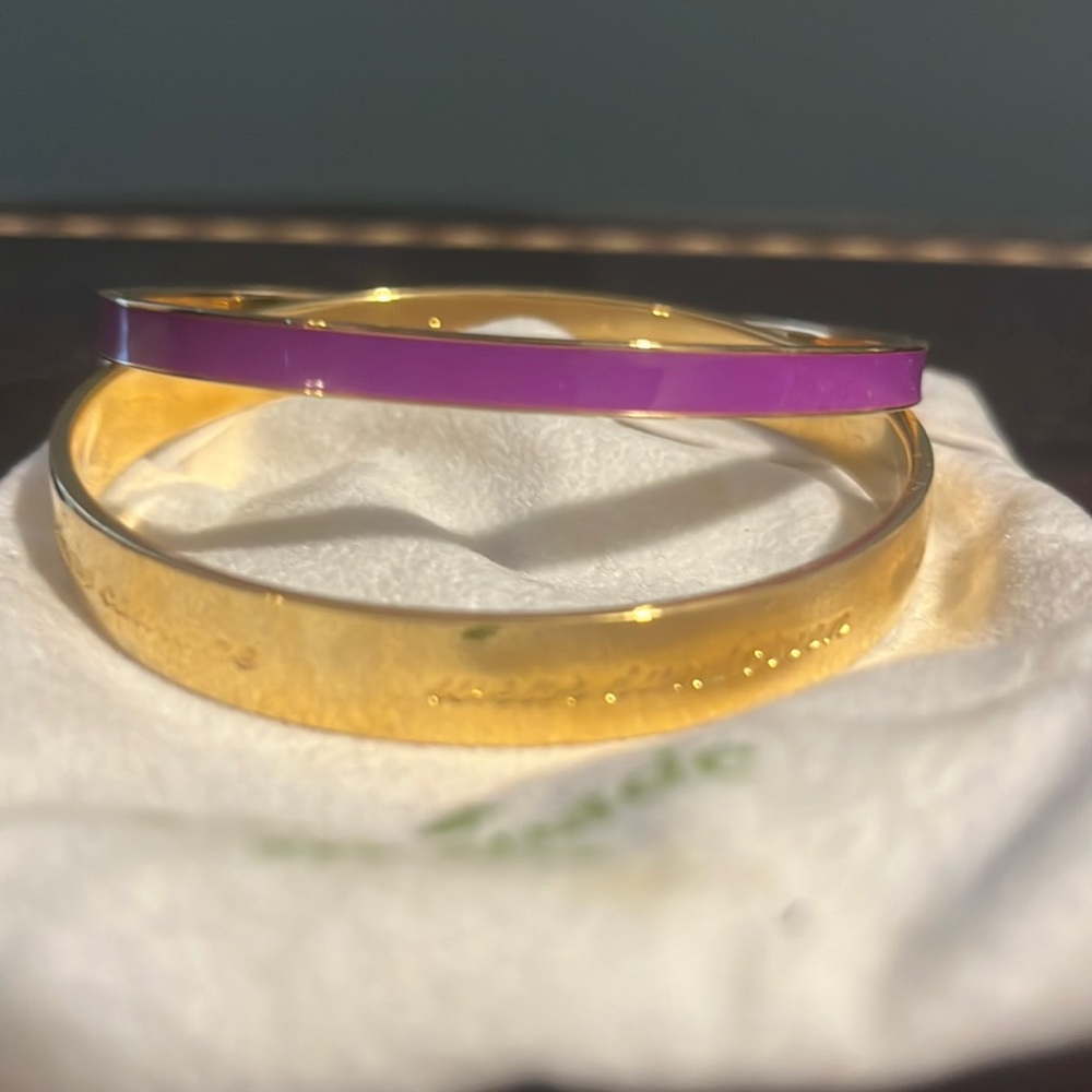 Kate Spade bangles one gold and purple one gold with motivational says